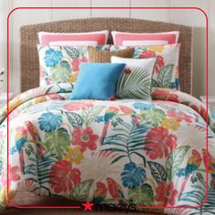 a bed with colorful flowers and leaves on it