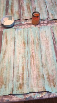 a wooden table topped with a bowl of food and a napkin on top of it