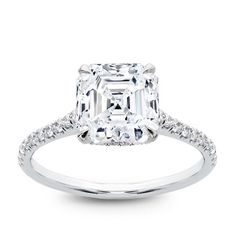 an emerald cut diamond ring with pave set shoulders