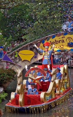 a carnival float in the water with people on it