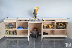 a workbench with tools and other items in it, including a driller