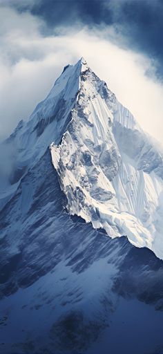 a very tall snow covered mountain peak in the middle of cloudy skies with clouds around it