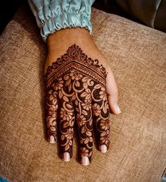 a woman's hand with henna on it