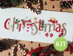 a cross stitch christmas sign surrounded by candy canes