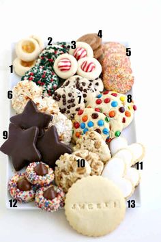 a white plate topped with lots of different types of cookies