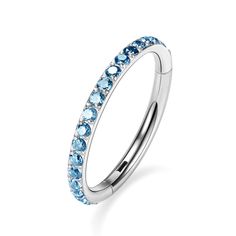 a ring with blue topaz stones on the inside and outside, set in white gold