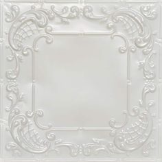 a white tile with an ornate design on it