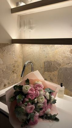 a bouquet of flowers sitting on top of a sink