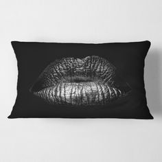 a black and white pillow with an image of a woman's lips on it