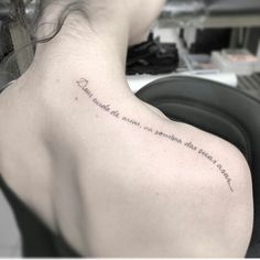 the back of a woman's shoulder with an inscription on it