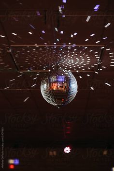 a disco ball hanging from the ceiling in a dark room