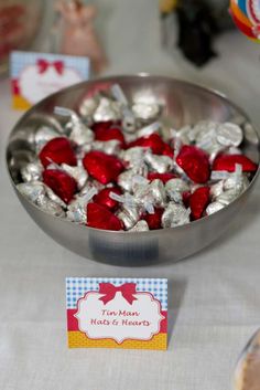 a bowl filled with candy sitting on top of a table