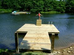 a man standing on top of a wooden dock