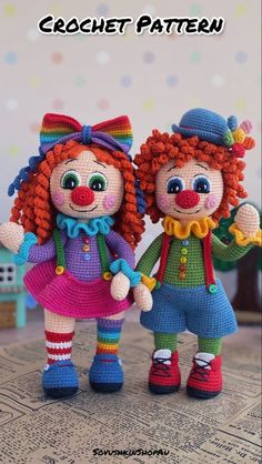 two crocheted dolls standing next to each other