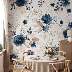 a dining room table with two chairs and a floral wallpaper on the wall behind it