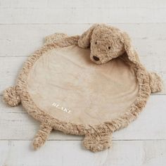 a stuffed animal laying on top of a wooden floor