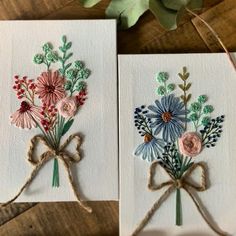 two cards with flowers on them tied together