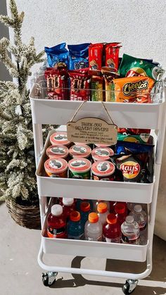 a white cart filled with drinks and snacks