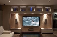 a large flat screen tv mounted to the side of a wall in a living room