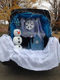 a car decorated with snowmen and decorations