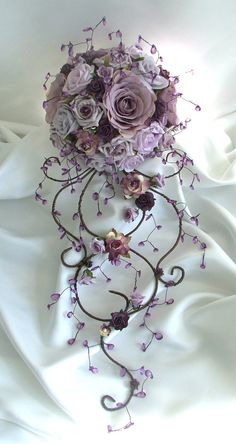 a bridal bouquet with purple flowers and vines