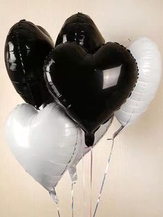 black and white balloons in the shape of hearts