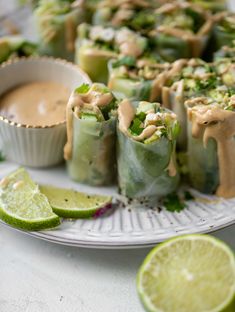 some food is sitting on a plate with limes and other foods around it that are ready to be eaten