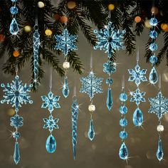 several blue snowflakes hanging from a christmas tree