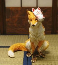 a figurine of a fox sitting on top of a mat