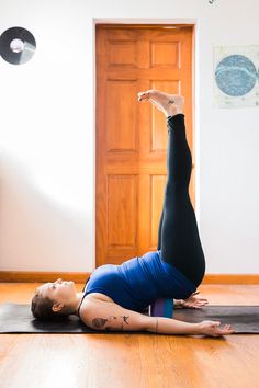 a woman is doing yoga on the floor