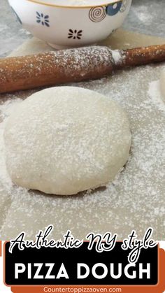 a pizza dough sitting on top of a counter next to a bowl and rolling pin