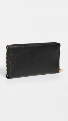 The Robinson Zip Continental Wallet is the perfect everyday companion for your busy lifestyle. Crafted from premium saffiano cowhide leather with a distinctive gold-tone emblem, it offers sleek organization and security with an exposed zipper closure and zipped interior pocket. Card slots, pockets, and an 8oz weight provide sturdy storage and portability to discreetly carry cash, cards, receipts and more. An optional wristlet keeps essentials close at hand. Slip it into a purse, bag or jacket po Classic Formal Clutch With Zipper Closure, Formal Clutch Wallet With Zipper Closure, Classic Clutch Wallet With Zipper Closure, Leather Evening Wallet With Zipper Closure, Elegant Leather Wallet With Zipper Closure, Leather Bifold Clutch With Zipper Closure, Classic Formal Wallet With Zipper Closure, Elegant Bifold Wallet With Zipper Pocket, Tory Burch Robinson