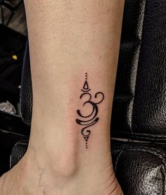 a woman's foot with a small tattoo on the left side of her ankle