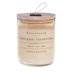 lemongrass and coconut milk candle in a glass jar with a wooden lid on a white background