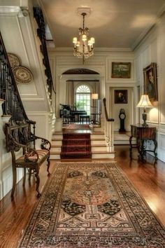 an ornately decorated hallway with stairs and rugs