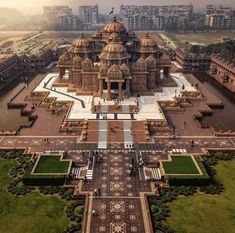 an aerial view of a large building in the middle of a park