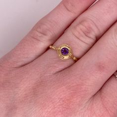 This stunning amethyst set in yellow gold is is sure to take your breath away! This ring provides a look that is very modern yet classic. This ring is very fashionable and can add a touch of style to any outfit, yet it is also classy enough to pair easily with formal wear. It looks beautiful by itself but also looks wonderful in a stack or as a wedding band! This ring would make the perfect gift for yourself or your loved one!14K Yellow GoldGemstone: AmethystGemstone Weight: .22 CaratsGemstone S Luxury Yellow Gold Amethyst Ring With Bezel Setting, Luxury Purple Ring With Bezel Setting, Luxury Gold Amethyst Ring With Bezel Setting, Modern Gold Amethyst Ring, Elegant Amethyst Birthstone Ring Round Band, Elegant Amethyst Birthstone Ring In Round Band, Yellow Gold Sapphire Ring With Gemstone Accents, Luxury Gold Amethyst Ring With Center Stone, Gold Amethyst Ring With Diamond Accents