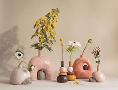 various vases with flowers in them sitting on a table