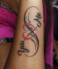 a woman's arm with a tattoo that says love and two hearts on it