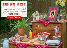 a wooden table topped with lots of food next to a potted plant and vases