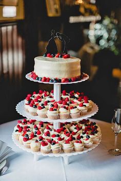 three tiered cake with red, white and blue cupcakes on each layer