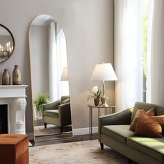 a living room filled with furniture and a large mirror