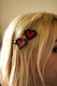 a woman with blonde hair wearing two red and black hearts on it's head