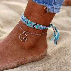 a woman's feet with two different bracelets on her ankles and one ankle