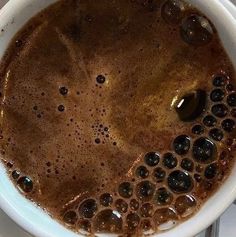 a bowl filled with liquid sitting on top of a table