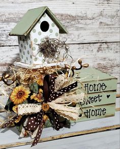 a birdhouse with sunflowers and other decorations