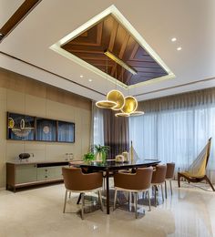 an elegant dining room with high ceilings and modern lighting fixtures in the middle of the room