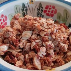 a bowl filled with granola sitting on top of a table