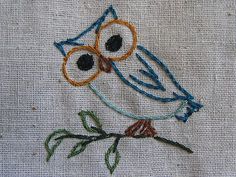 an embroidered owl is sitting on a branch