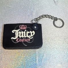 a black keychain with the word juicy written on it and a pink crown